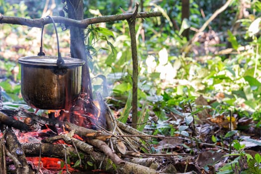 Cooking food at a campsite deep within the Amazon rainforest in Peru