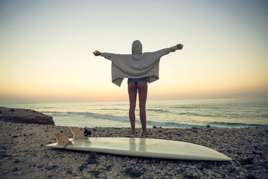 Beautiful female Surfer looking for the waves