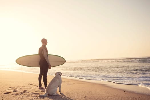 Surfist on the beach with his best friend