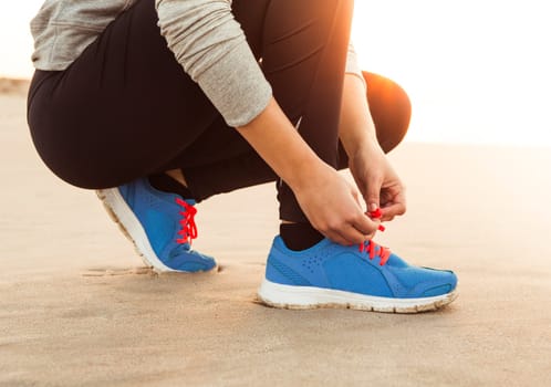 Runner woman tying the shoelaces
