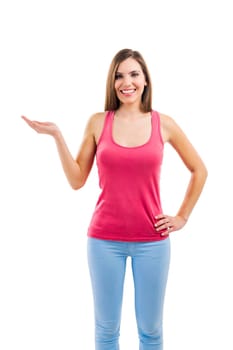 Beautiful brunette woman laughing and pointing to the side, isolated over white background