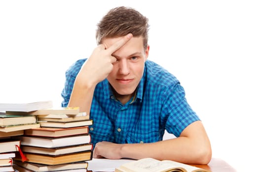 a pissed off teenage student with a pile of books next to him