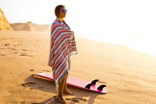 Beautiful female Surfer looking for the waves