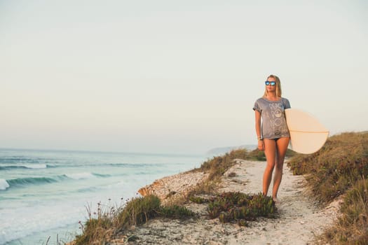 Beautiful female Surfer looking for the waves