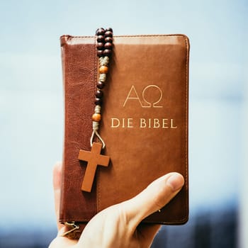 Young preacher is holding the holy bible, praying