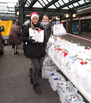 Yasmina Filali, german actress and model and  Max Bryon distributed Christmas bags from Hamburger Homeless Aid e.V. to the homeless and needy at Hamburg Central Station
