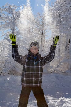 A snow covered landscape Czech Republic - Pustevny, Beskydy. Boy play with snow.