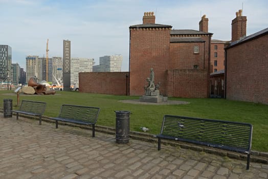 Liverpool, United Kingdom, 2nd February, 2020: Three empty benches in front of the pier masters house at the Royal Albert Dock waterfront.