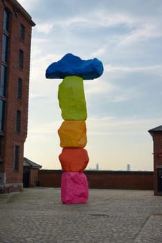 Liverpool, United Kingdom, 2nd February, 2020: Full frame image of the colorful, modern and abstract sculpture by Ugo Rondinone outside tate gallery