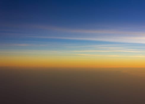 Sky and clouds at sunset bird's eye view on the plane