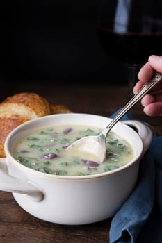 Portuguese Caldo Verde soup with spoon.  Vertical format with copy space.