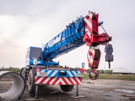 Construction site crane is lifting a led signboard Blank billboard on blue sky background for new advertisement