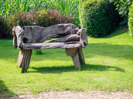 Old wooden table set  in the green garden.