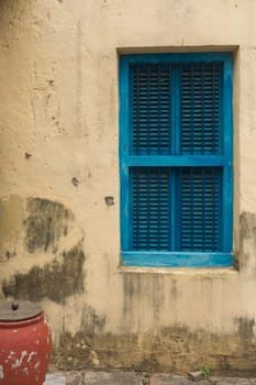 Blue shutters on a yellow wall, in Zanzibar africa.