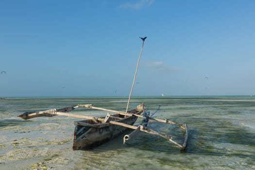 fishing boat on the shores of Zanzibar at low tide, the ocean.