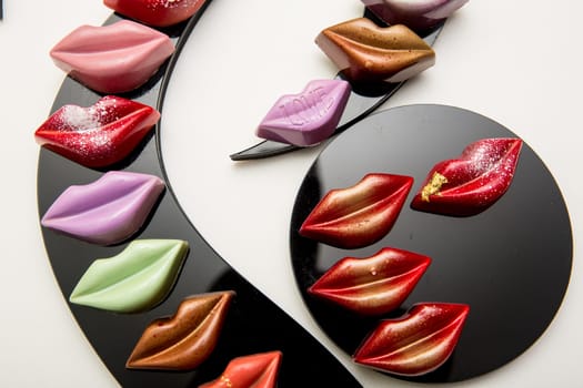 Delicious chocolate candies, close up, different colors.