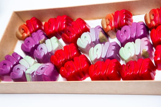 Delicious chocolate candies, close up, different colors.
