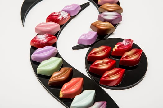 Delicious chocolate candies, close up, different colors.