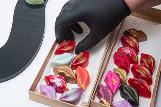 Delicious chocolate candies, close up, different colors.