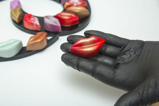 Delicious chocolate candies, close up, different colors.