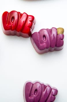 Delicious chocolate candies, close up, different colors.