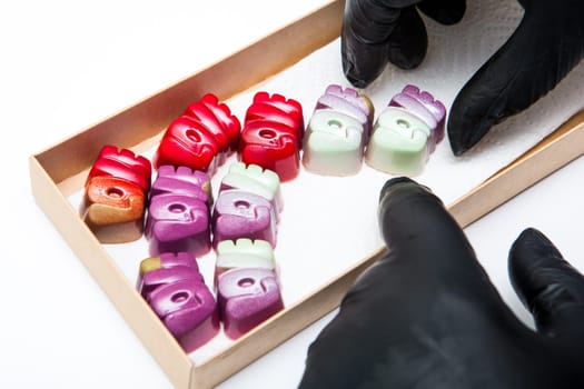Delicious chocolate candies, close up, different colors.