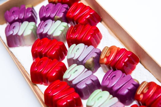 Delicious chocolate candies, close up, different colors.