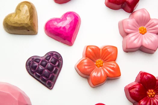 Delicious chocolate candies, close up, different colors.