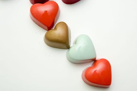 Delicious chocolate candies, close up, different colors.