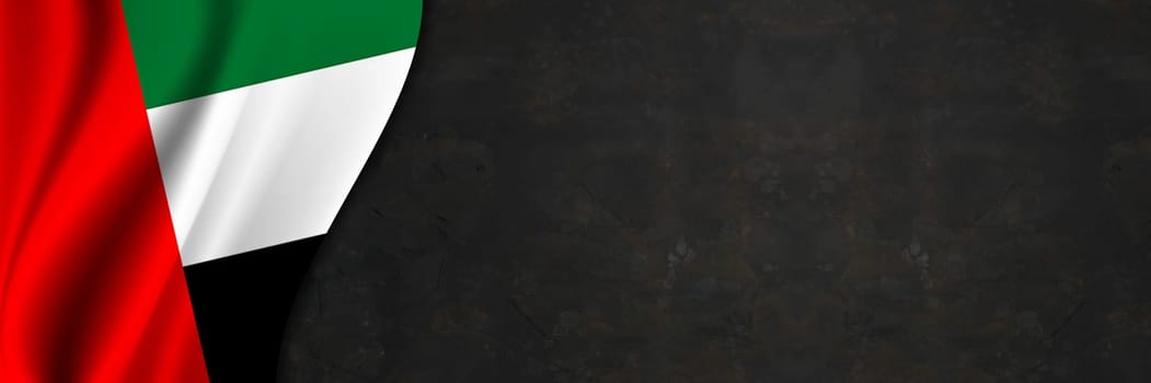 United Arab Emirates flag on concrete wall. Banner with fabric texture of the flag of United Arab Emirates.
