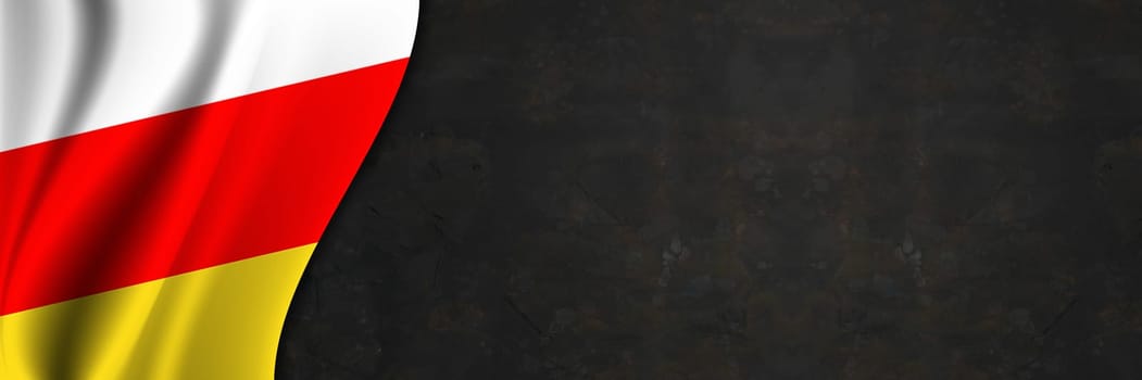 South Ossetia flag on concrete wall. Banner with fabric texture of the flag of South Ossetia.