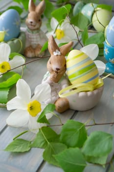 Easter decoration with rabbit, spring flowers and eggs. Vertical image