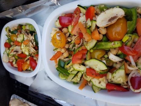 Grilled vegetables on a barbecue grill in a white bowl, top view