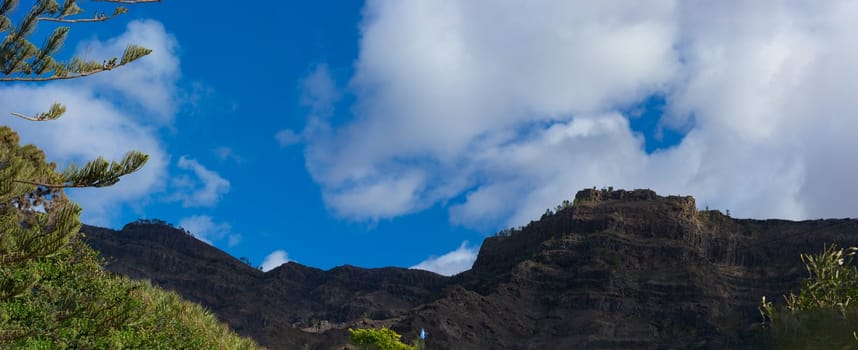Mountains on the coast between Puerto de Mogan and Puerto Rico. Layers of volcanic rock.