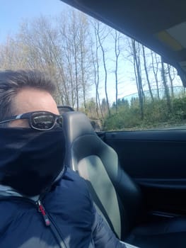 Shot of a serious looking man wearing a mask and sunglasses on infectious diseases.