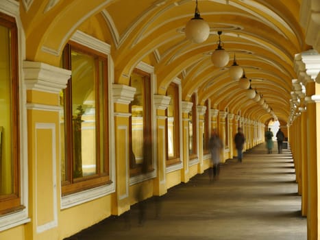 shopping arcade people walk into the distance blurry motion