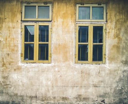 Architectural Details Vintage Window with Peeling Paint in orange.  Old vintage window of house old fashion design classic on rustic painted concrete wall background