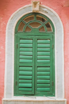 Vintage arched shutters, two panel rustic Mediterranean Shutter. Old wooden vintage louver window. Blinds Window Shutter Plantation Shutter in brown.