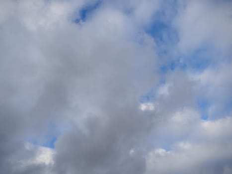 Stratus clouds, cirrus light above and cumulonimbus dark below, cloudscape