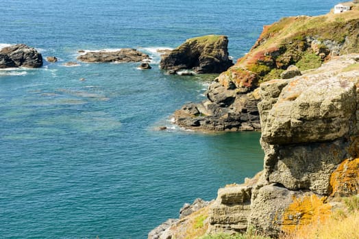 landscape of coastline with cliffs and rocks of touristic location in Cornwall .