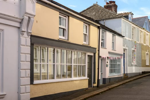 view of narrow street with old houses in the village on southern coast of Cornwall.