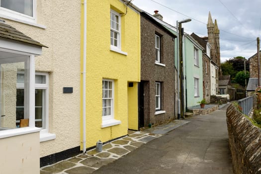 view of street with old houses in the village on southern coast of Cornwall.