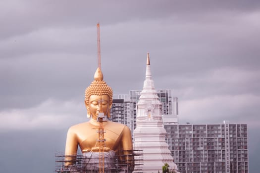 June 2020 Bangkok Thailand Giant golden Buddha under construction change skyline in Bangkok at Wat Paknam temple in Phasi Charoen district of Bangkok.