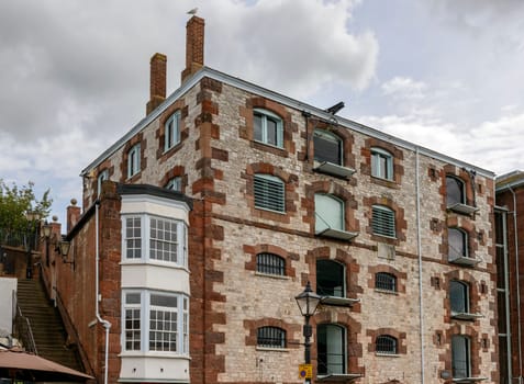 view of old industrial  building near the river Exe that flows in town center.