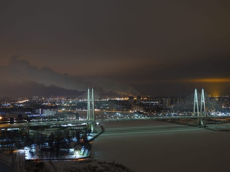 skyline St. Petersburg  illuminated at night, cable-stayed bridge in the foreground