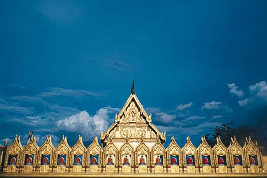 May 2020 Thailand Golden temple in Pathumthani Thailand monk Buddhist saint  statue  of Buddhists gather at Thai temple against blue sky in summer