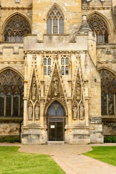 detail of lateral entrance portal of ancient  stone church in historic town of Devon.