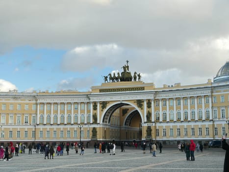 St. Petersburg, Russia, March 4, 2021. People crowd walking at the Arch of the General Staff with a bronze chariot on the Palace Square
