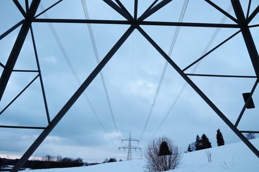 Overhead line pylons with power cables in winter