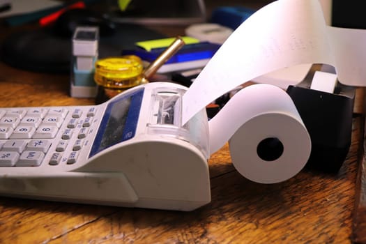 Closeup of the paper roll on a calculator adding machine.